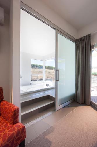 a room with a sliding glass door with a bath tub at Longview Vineyard in Macclesfield