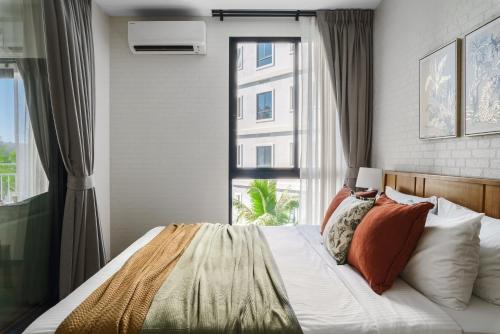 a bedroom with a bed with a large window at Title Halo Nature Touch 40m2 King Bed Naiyang in Nai Yang Beach
