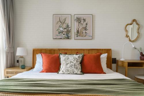 a bedroom with a bed with orange and white pillows at Title Halo Nature Touch 40m2 King Bed Naiyang in Nai Yang Beach