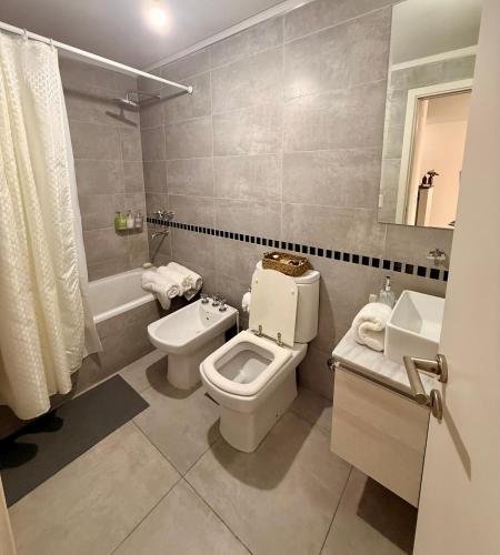 a bathroom with a toilet and a sink at City Paz in Villa Carlos Paz