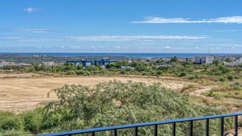 a view of a field and the ocean from a balcony at Sudcalifornia 301, 2 Rec, bonita vista y rooftop in San José del Cabo