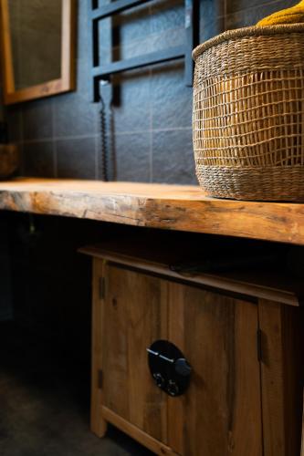 a wooden counter with a basket on top of it at Ciemzeres 2 in Engure