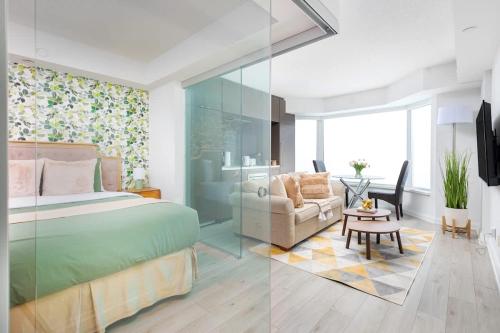 a bedroom with a bed and a living room at Plush Yorkville Designer Condo with Glam Suite in Toronto