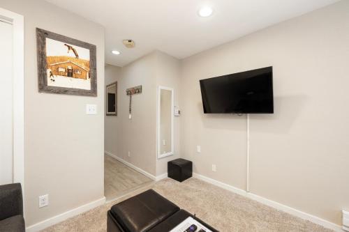 a living room with a flat screen tv on the wall at Guest Suite Downtown Winter Park GREAT LOCATION in Winter Park