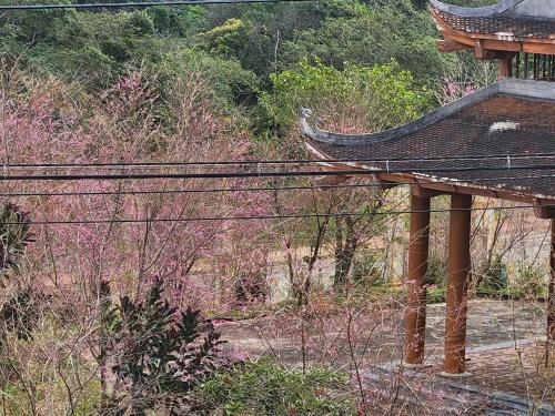 an outside view of a building with a roof at Như Ý Hotel in Kon Plong