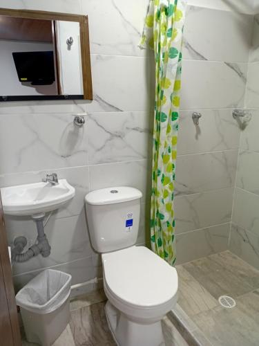 a bathroom with a toilet and a sink at Casa Alto de la Virgen DeMaiz in Choachí