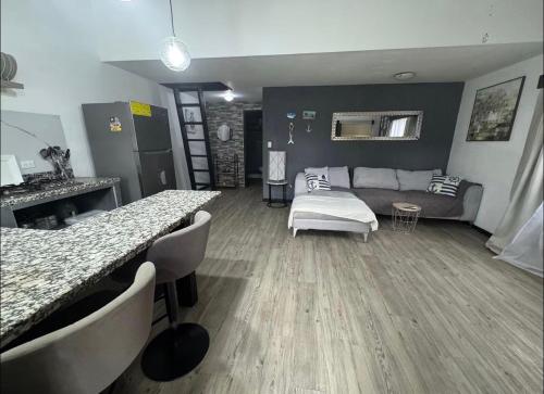 a living room with a couch and a table at Casa Bambu in Tapantí