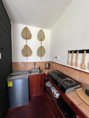 a small kitchen with a sink and a stove at Chinuk Boutique Hotel in Puerto Viejo