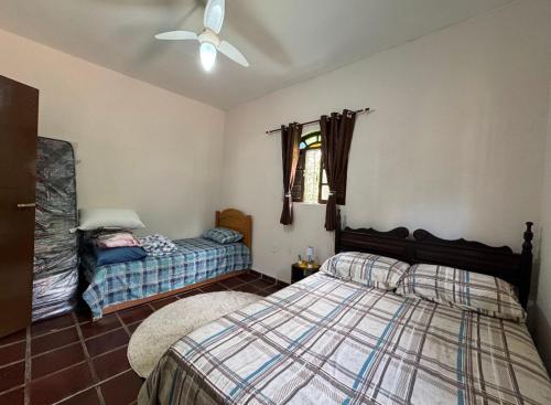 Кровать или кровати в номере Sítio Paulinha e Rodrigão Classic bodybuilder