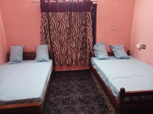 Voodi või voodid majutusasutuse Ashabhavan toas