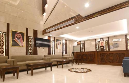 a lobby with couches and tables in a building at رتاج إن in Al Khansāk