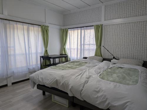 Ένα ή περισσότερα κρεβάτια σε δωμάτιο στο Manga House Awesome Shino