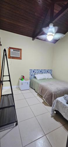 a bedroom with a bed and a ladder in it at Pousada Paraíso Guapi in Guapimirim