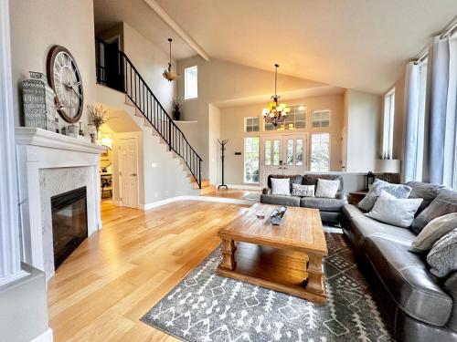a living room with a couch and a coffee table at Chef's Kitchen Pool Bright, Spacious 4 Bed in Medford