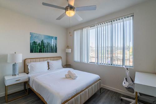 a bedroom with a bed and a large window at Stylish Studio-1BR 1BA, Pool, Gym, Free Parking, Game Room, EV in Tempe