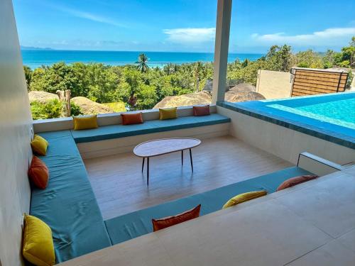 a view of a swimming pool with a table and a table at Villa Sabanya Sea View in Ban Nua