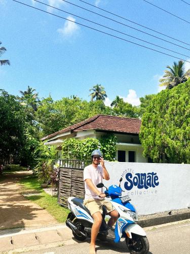a man is riding a scooter on the street at Solmate Collective Guesthouse - Madiha in Matara