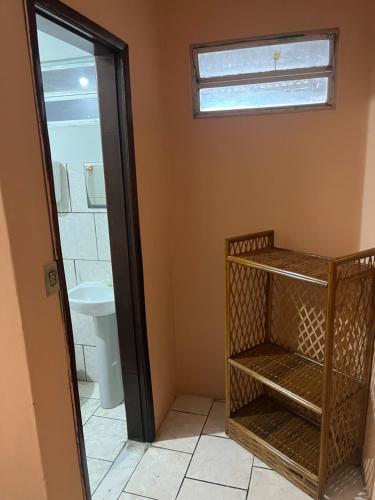 a bathroom with a toilet and a sink and a mirror at Pousada Sossego in Pojuca