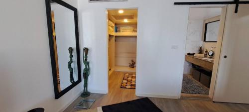 a hallway with a mirror and a walk in closet at Stylish New Condo in NANA in Bang Kapi