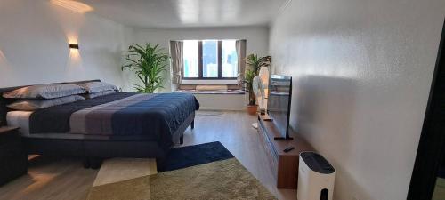 a bedroom with a bed and a window at Stylish New Condo in NANA in Bang Kapi