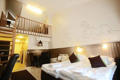 a hotel room with a bed and a staircase at Hotel Hullu Poro in Levi