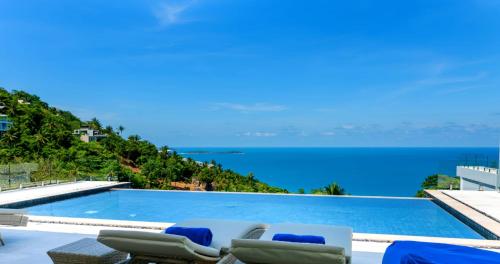 a swimming pool with a view of the ocean at BLUE BUTTERFLY Luxury Pool Villa Koh Samui 5 Bedrooms in Koh Samui 