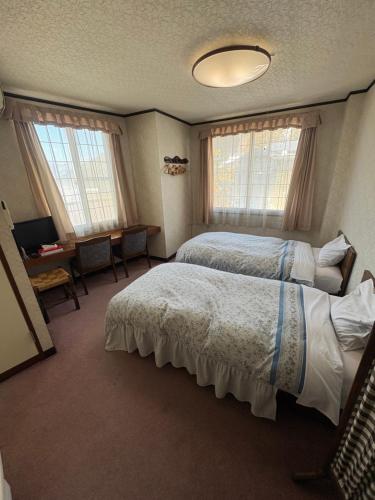 Ένα ή περισσότερα κρεβάτια σε δωμάτιο στο お宿まるとや