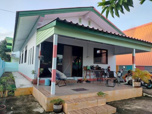 a small white house with a patio at Soi Saliga in Rawai Beach