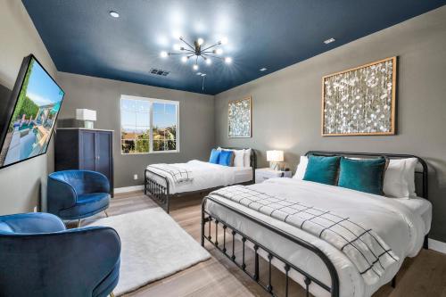 a bedroom with two beds and a tv in it at Turquoise Mirage Fun House in Indio