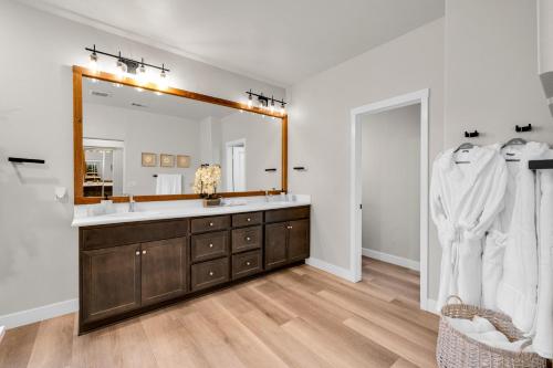 a bathroom with a sink and a large mirror at Turquoise Mirage Fun House in Indio