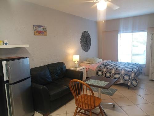 a living room with a couch and a bed at Pinellas Park Oasis in St Petersburg