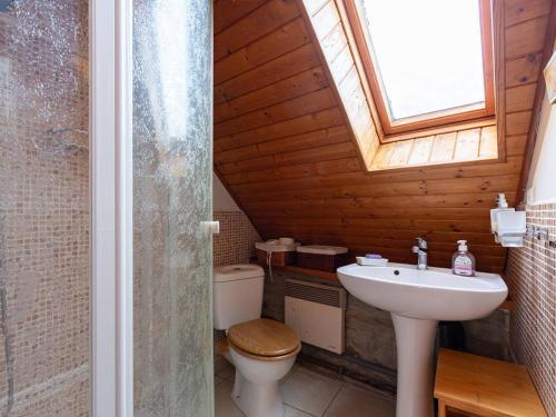 a bathroom with a sink and a toilet and a window at Maison pour 5 à Génos proche lac et station avec WiFi - FR-1-695-94 in Génos