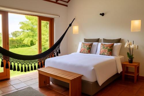 a bedroom with a bed and a large window at Chalet Privado in Villa de Leyva