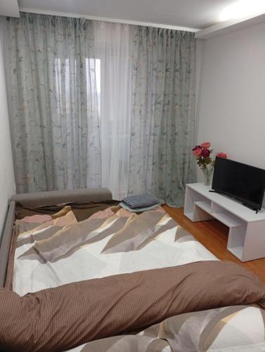 מיטה או מיטות בחדר ב-2 bedroom Puskin