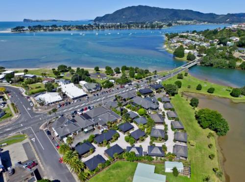 an aerial view of a village next to a river at Tairua Getaway in Tairua