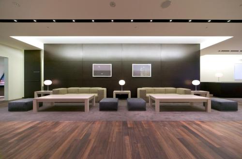 a waiting area with couches and tables in a building at Hotel Sunroute Tokushima in Tokushima