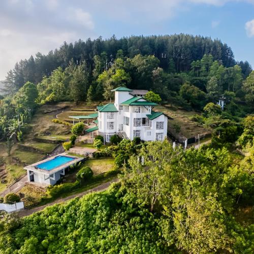 an aerial view of a large house on a hill at The Colonial Crest in Nillambe