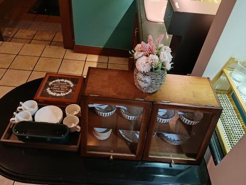 a table with a vase of flowers on top of it at Grand Pool Villa Luxury Resort Port Dickson in Port Dickson