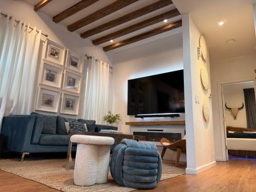 a living room with a blue couch and a tv at A Dedicated Space To Unwind in Brooklyn