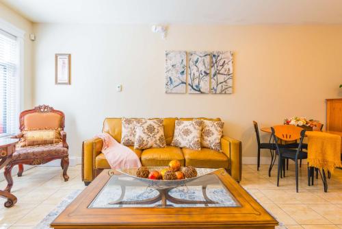 a living room with a couch and a table at Beach Breeze White Rock in White Rock