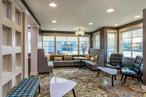 a waiting room with couches and chairs and windows at Residence Inn by Marriott Denver Airport at Gateway Park in Aurora