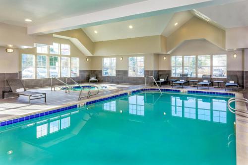 a large pool with blue water in a building at Residence Inn by Marriott Denver Airport at Gateway Park in Aurora