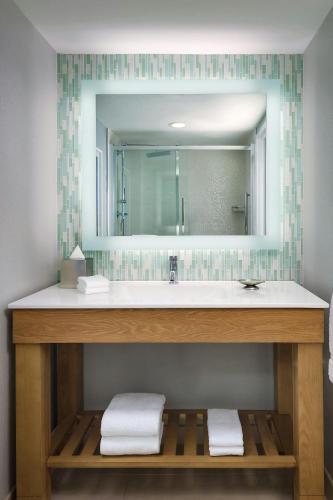 a bathroom with a sink and a mirror at Walt Disney World Swan in Orlando