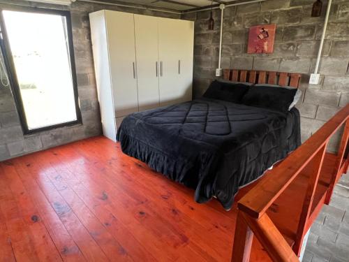 a bedroom with a bed in a room with a window at Altos de Arenas in Miramar