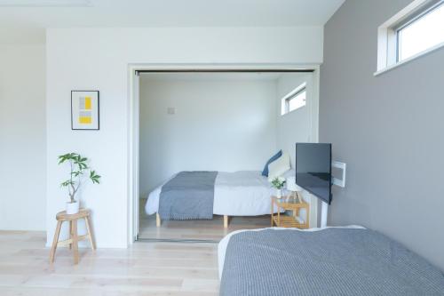 a bedroom with a bed and a sliding glass door at Sion NAGOYA in Nagoya