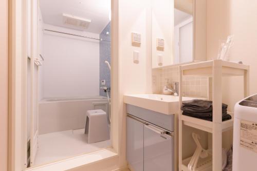 a small bathroom with a sink and a shower at Sion NAGOYA in Nagoya
