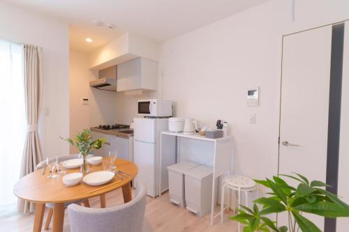 a kitchen and dining room with a table and chairs at Sion NAGOYA in Nagoya
