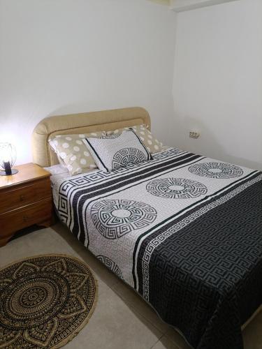 a bedroom with a bed and a nightstand with a bed sidx sidx at Kipseli house in Athens