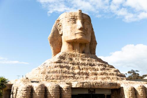 a statue of a head on top of a building at Sphinx Hotel in Hamlyn Heights