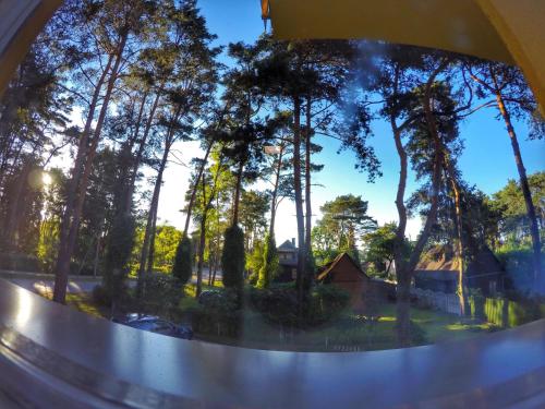 a view of a reflection of trees in a mirror at Kambarių nuoma Kačerginės kurorte in Kačerginė